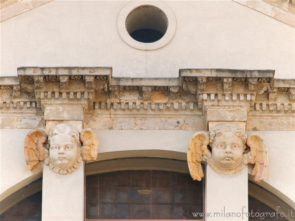 Milan (Italy) - Heads of cherub on the never-ending facade of the Basilica of San Vittore